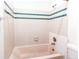 Clean bathroom with a tub and tiled walls at 6435 S Dayton St # 108, Englewood, CO 80111