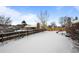 Snowy backyard with wooden fence; winter view at 8111 S Marion Ct, Centennial, CO 80122