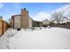 Home's exterior and backyard covered in snow at 8111 S Marion Ct, Centennial, CO 80122