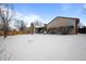 Snow covered backyard with home partially visible at 8111 S Marion Ct, Centennial, CO 80122