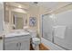 Neat bathroom with tub and shower, and a marble countertop at 8111 S Marion Ct, Centennial, CO 80122