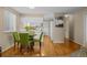 Small dining area with green chairs and wood floors at 8111 S Marion Ct, Centennial, CO 80122