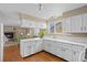 Kitchen with white cabinets, wood floors, and breakfast bar at 8111 S Marion Ct, Centennial, CO 80122