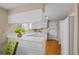 Galley kitchen with white cabinets and a breakfast bar at 8111 S Marion Ct, Centennial, CO 80122