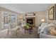 Cozy living room featuring a fireplace and sliding glass door leading to a patio at 8111 S Marion Ct, Centennial, CO 80122