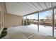 Covered patio overlooking fenced backyard; winter scene at 8111 S Marion Ct, Centennial, CO 80122