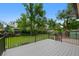Exterior deck provides serene view of a large backyard with mature trees and garden at 9025 W 4Th Ave, Lakewood, CO 80226
