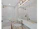 Bathroom with Marble walls and countertop, gold fixtures, and a large mirror at 9025 W 4Th Ave, Lakewood, CO 80226