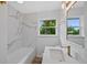 Modern bathroom with marble backsplash, granite counters, and updated fixtures at 9025 W 4Th Ave, Lakewood, CO 80226