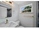 Bathroom features granite countertop, updated fixtures, and a window offering outdoor views at 9025 W 4Th Ave, Lakewood, CO 80226