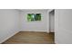 Bedroom with hardwood floors, large window, closet, and neutral decor at 9025 W 4Th Ave, Lakewood, CO 80226