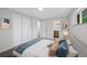 Bright bedroom with a white closet, an open door to the bathroom, and modern decor at 9025 W 4Th Ave, Lakewood, CO 80226