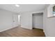 White Bedroom with Hardwood Floors, Closet, Window, and Neutral Decor at 9025 W 4Th Ave, Lakewood, CO 80226