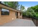 Wide deck features metal railing and a view to the property at 9025 W 4Th Ave, Lakewood, CO 80226