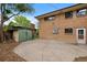 Backyard area showing house, brick siding, storage shed and concrete patio at 9025 W 4Th Ave, Lakewood, CO 80226
