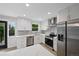 Modern kitchen featuring quartz countertops, stainless steel appliances, and white cabinetry at 9025 W 4Th Ave, Lakewood, CO 80226