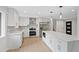 Stunning kitchen with white cabinetry, quartz countertops, stainless steel appliances, and a center island at 9025 W 4Th Ave, Lakewood, CO 80226