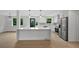 Modern kitchen with white cabinets, marble countertops, stainless steel appliances, and a large center island at 9025 W 4Th Ave, Lakewood, CO 80226