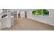 Spacious living room featuring hardwood floors, access to the kitchen, and bright natural light at 9025 W 4Th Ave, Lakewood, CO 80226