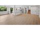 Open-concept living room with an adjacent kitchen, hardwood floors, and natural light at 9025 W 4Th Ave, Lakewood, CO 80226