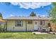 Back of house view highlighting an outdoor patio area and well-maintained lawn at 2208 Emery St, Longmont, CO 80501