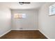 Bedroom featuring hardwood floors, fresh paint, and natural light from two windows at 7891 Maria St, Westminster, CO 80030