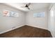 Empty bedroom features hardwood floors, fresh paint, and natural light from two windows at 7891 Maria St, Westminster, CO 80030