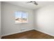 Bedroom featuring hardwood floors, fresh paint, a ceiling fan, and a new window at 7891 Maria St, Westminster, CO 80030