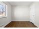 An empty bedroom featuring hardwood floors, fresh paint, and a new window at 7891 Maria St, Westminster, CO 80030