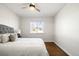 Bright bedroom featuring a ceiling fan, and hardwood flooring, and a large window at 7891 Maria St, Westminster, CO 80030