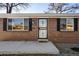 Close-up of the brick facade, front door with decorative security screen, and well-kept yard at 7891 Maria St, Westminster, CO 80030