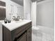 Clean bathroom featuring vanity with dark cabinets and white countertop, tiled shower, and modern fixtures at 480 S Marion Pkwy # 1202, Denver, CO 80209