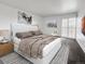 Inviting bedroom featuring a comfortable bed, stylish decor, and sliding glass door at 480 S Marion Pkwy # 1202, Denver, CO 80209