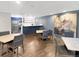 Inviting common area featuring tables, chairs, and an open kitchen with stainless steel appliances at 480 S Marion Pkwy # 1202, Denver, CO 80209