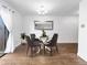 Bright dining area featuring hardwood floors, modern lighting, round table with four chairs and view to the side at 480 S Marion Pkwy # 1202, Denver, CO 80209