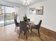 Dining room with hardwood floors, table, and balcony access, perfect for entertaining at 480 S Marion Pkwy # 1202, Denver, CO 80209