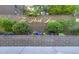 The Park Lane sign sits in front of a brick retaining wall lined with landscaping and colorful flowers at 480 S Marion Pkwy # 1202, Denver, CO 80209