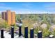View from patio overlooking trees, neighborhood, and another tall building in distance at 480 S Marion Pkwy # 1202, Denver, CO 80209