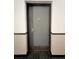 Image of front door in hallway featuring dark hardwood floors with dark trim at 480 S Marion Pkwy # 1202, Denver, CO 80209
