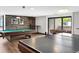Spacious game room with a pool table, ping pong table, and foosball for entertainment at 480 S Marion Pkwy # 1202, Denver, CO 80209