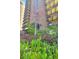 Well maintained landscaping features the building exterior with lovely foliage and a blooming tree at 480 S Marion Pkwy # 1202, Denver, CO 80209