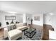 Inviting living room featuring a neutral sectional, modern coffee table, and hardwood flooring at 480 S Marion Pkwy # 1202, Denver, CO 80209