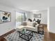 Cozy living room features hardwood floors, modern decor, and sliding doors to a balcony with a view at 480 S Marion Pkwy # 1202, Denver, CO 80209