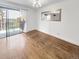 Bright living room with hardwood floors, balcony access, and lots of natural light at 480 S Marion Pkwy # 1202, Denver, CO 80209