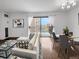 The living room features hardwood floors, sliding doors to a balcony, and an adjacent dining area at 480 S Marion Pkwy # 1202, Denver, CO 80209