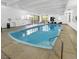 Indoor community pool with lounge chairs and windows for natural light at 480 S Marion Pkwy # 1202, Denver, CO 80209