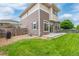 Multi-level home featuring a well-maintained lawn, fenced yard, and cozy patio area for outdoor enjoyment at 18112 E 104Th Way, Commerce City, CO 80022