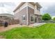 Multi-level home featuring a well-maintained lawn, fenced yard, and cozy patio area for outdoor enjoyment at 18112 E 104Th Way, Commerce City, CO 80022