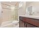 Modern primary bathroom with a glass shower enclosure, a dark wood vanity, and neutral tiling at 18112 E 104Th Way, Commerce City, CO 80022