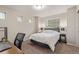 A bedroom including an office space with a black office chair, desk, and contemporary lamp at 18112 E 104Th Way, Commerce City, CO 80022